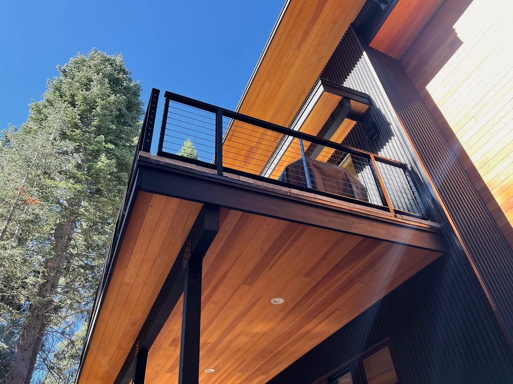 Steel cable railing on a second floor balcony, seen from below