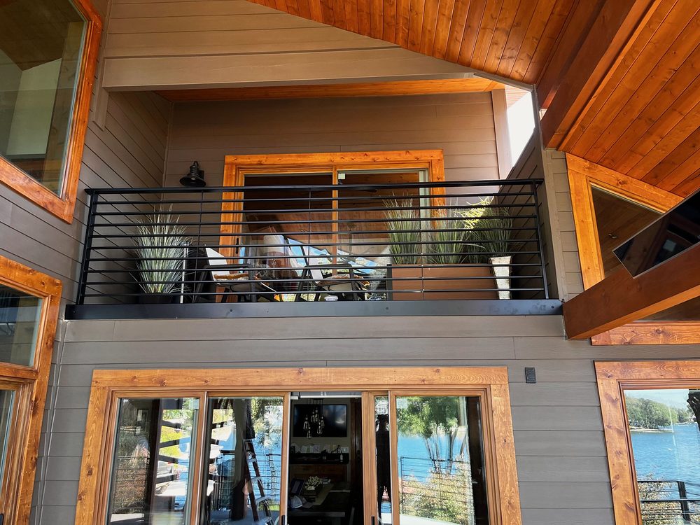 Black steel horizontal bar balcony railing on a lake house